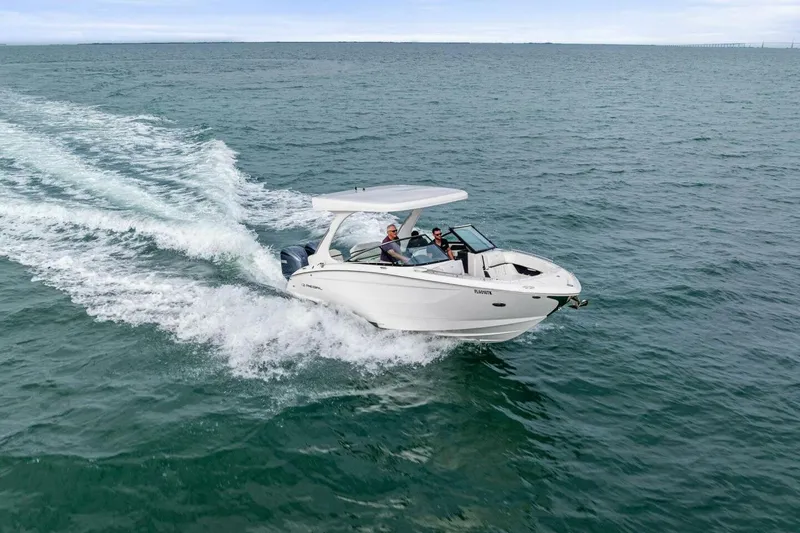Slide: The Image of 2023 Regal 29 OBX boat cruising on open water, showcasing sleek design and performance. - 42