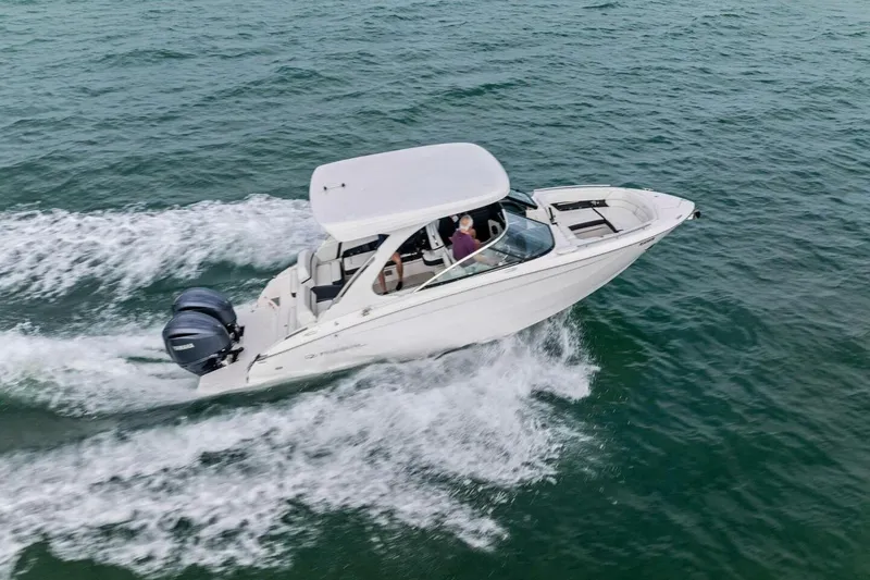 Slide: The Image of 2023 Regal 29 OBX boat cruising on open water, showcasing sleek design and powerful engines. - 45