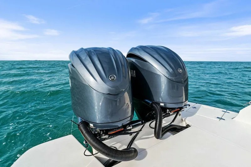 Slide: The Image of Twin outboard engines on a 2023 Regal 29 OBX boat, cruising on open water. - 6