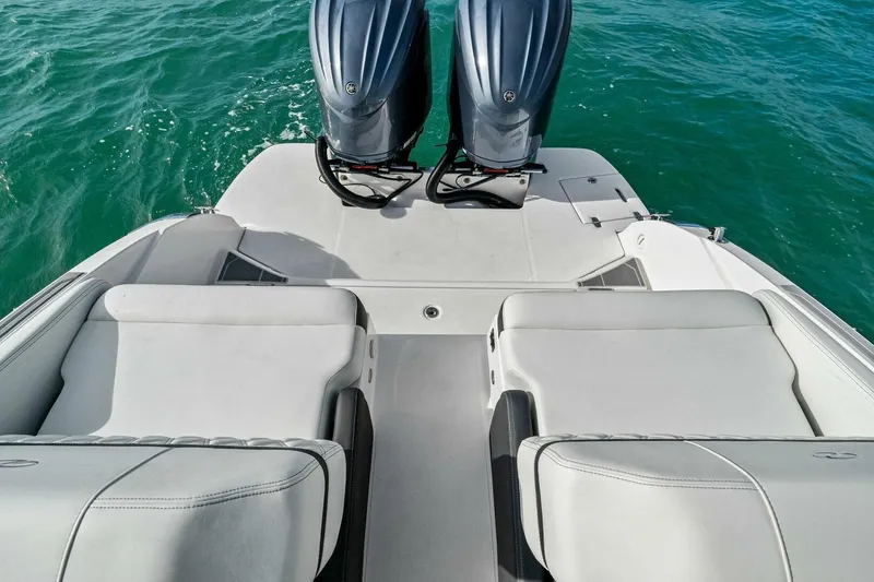 Slide: The Image of 2023 Regal 29 OBX boat with dual outboard engines on turquoise water. - 7
