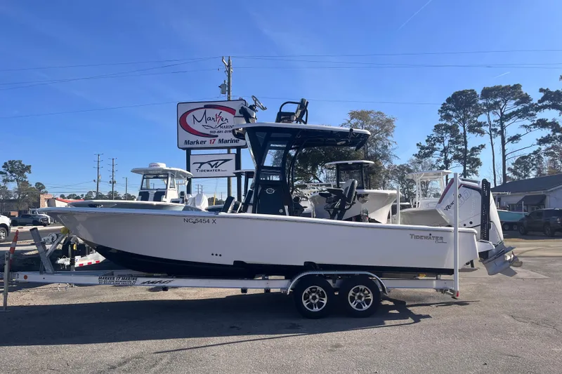 The Image of 2024 Tidewater 2500 Carolina Bay boat on trailer under clear blue sky. - 0