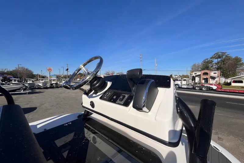 Slide: The Image of 2024 Tidewater 2500 Carolina Bay boat interior with helm and seating. - 16