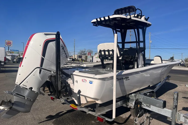 Slide: The Image of 2024 Tidewater 2500 Carolina Bay boat with powerful engine, parked outdoors. - 4