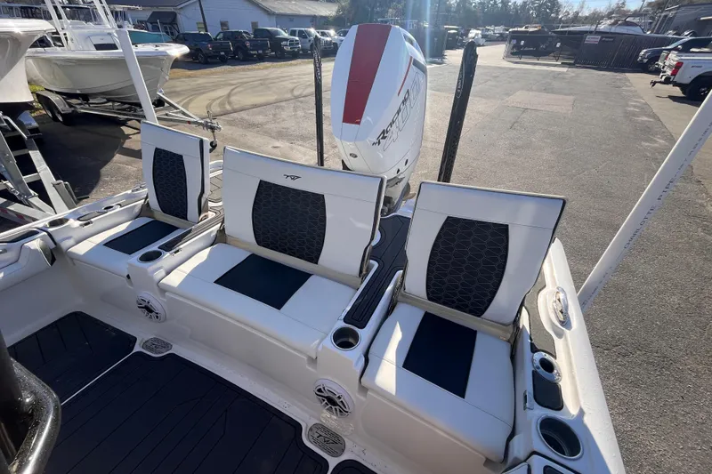 Slide: The Image of 2024 Tidewater 2500 Carolina Bay boat with T-top, docked under clear blue sky. - 5