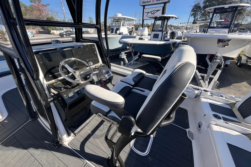 Slide: The Image of 2024 Tidewater 2500 Carolina Bay boat with sleek design and modern features in a marina setting. - 6