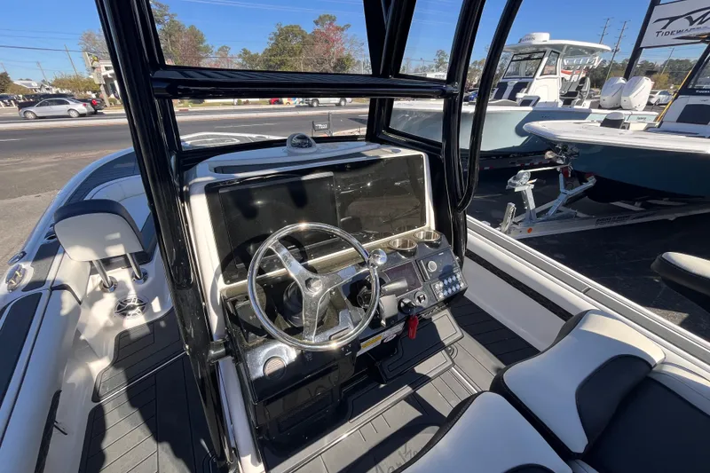 Slide: The Image of 2024 Tidewater 2500 Carolina Bay boat interior with steering wheel and seating. - 8