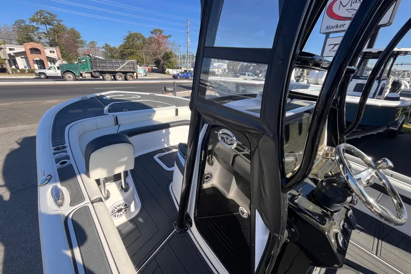 Slide: The Image of 2024 Tidewater 2500 Carolina Bay boat with sleek black T-top and speakers. - 9