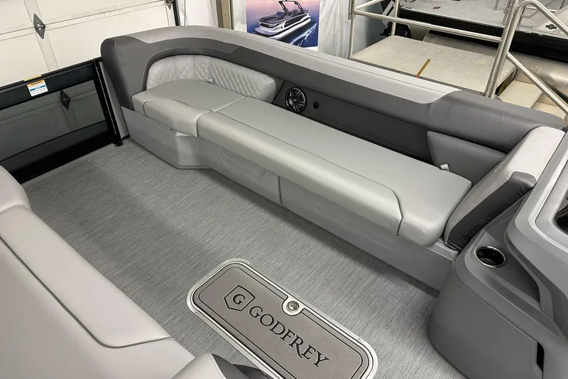 Slide: The Image of Interior of 2026 Godfrey Sweetwater 2486 SFL pontoon boat with gray seating and flooring. - 10