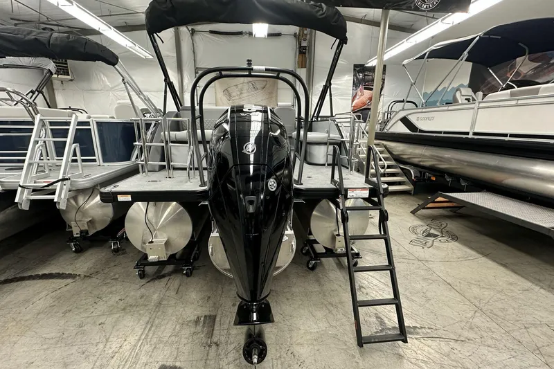 Slide: The Image of 2026 Godfrey Sweetwater 2486 SFL pontoon boat displayed in showroom with ladder and canopy. - 3