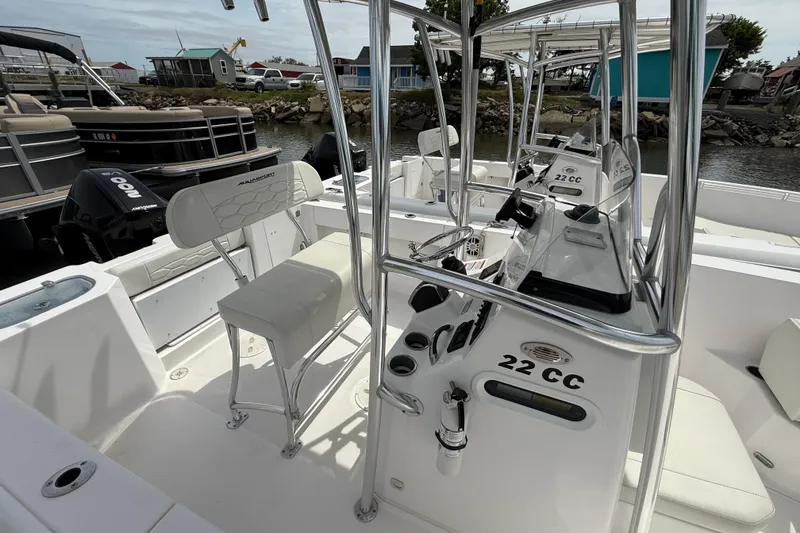 Slide: The Image of 2024 Aquasport 2200 Center Console boat interior with seating and controls. - 6