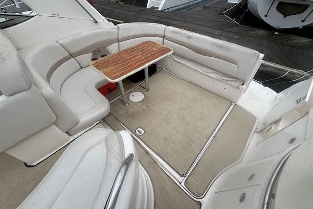Slide: The Image of 2002 Chaparral Signature 350 boat interior with beige seating and wooden table. - 10