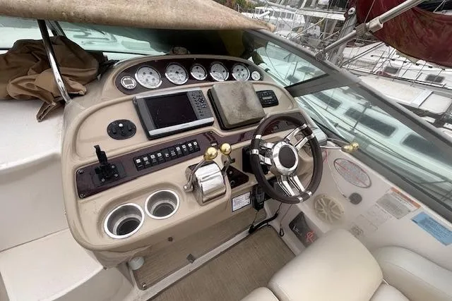 Slide: The Image of 2002 Chaparral Signature 350 boat dashboard with steering wheel and navigation instruments. - 13