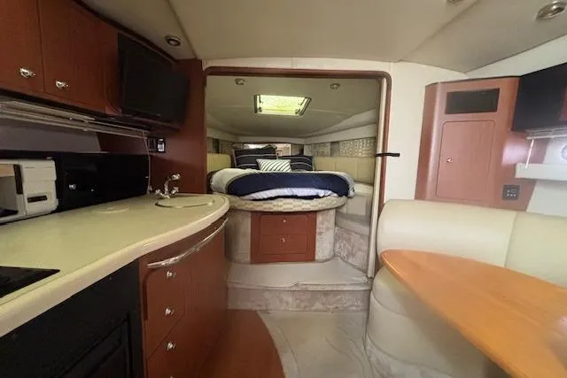 Slide: The Image of Interior of 2002 Chaparral Signature 350 yacht with cozy bed and kitchenette. - 16