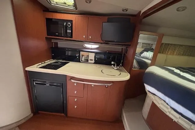 Slide: The Image of 2002 Chaparral Signature 350 yacht interior with kitchenette and sleeping area. - 17