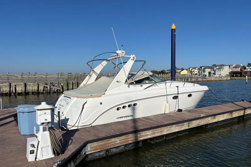 Slide: The Image of 2002 Chaparral Signature 350 boat docked at marina under clear blue sky. - 4