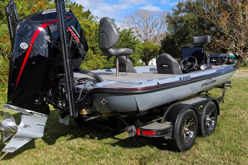 Slide: The Image of 2023 Falcon F195 boat on trailer, parked on grass, with Mercury Pro XS engine. - 4