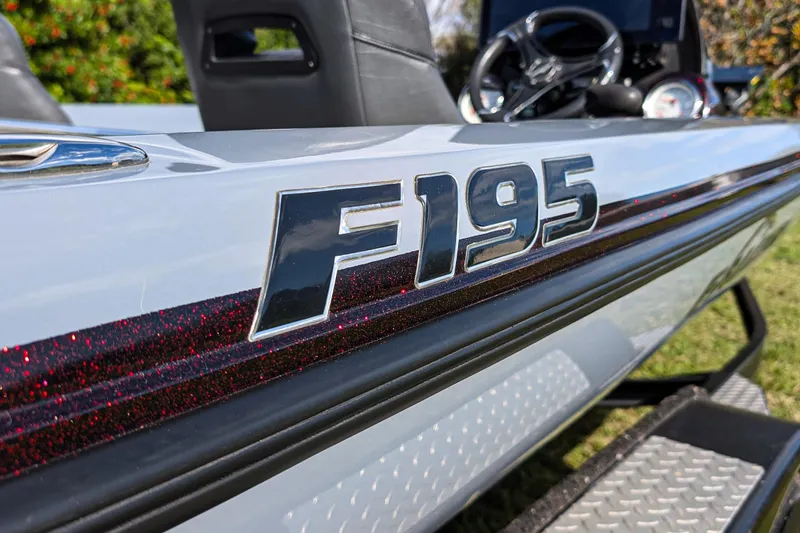 Slide: The Image of 2023 Falcon F195 boat on trailer, showcasing sleek design and dual wheels. - 6