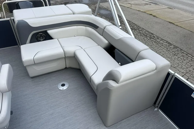 Slide: The Image of 2026 Godfrey SWEETWATER 2286 CSE boat interior with gray seating and speaker. - 5