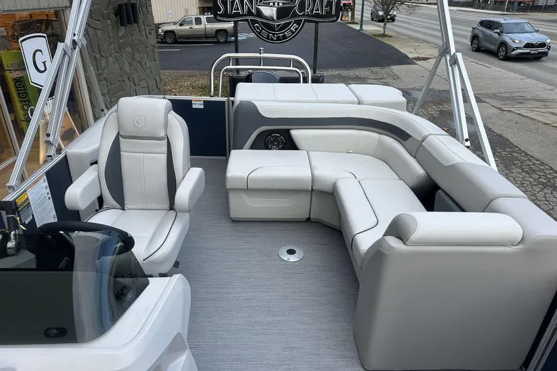 Slide: The Image of 2026 Godfrey SWEETWATER 2286 CSE pontoon boat interior with plush seating and captain's chair. - 6