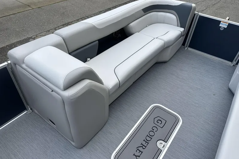 Slide: The Image of 2026 Godfrey SWEETWATER 2286 CSE boat interior with gray seating and flooring. - 7