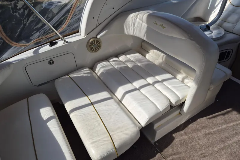 Slide: The Image of 2001 Sea Ray Sundancer 280 interior with white leather seating and speaker. - 10