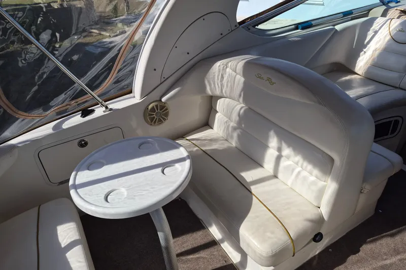 Slide: The Image of Interior of 2001 Sea Ray Sundancer 280 with white seating and small table. - 11