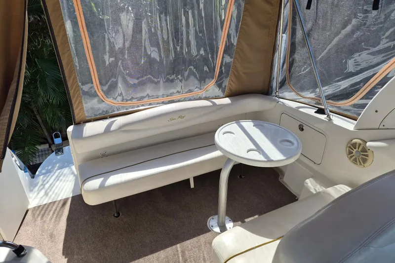 Slide: The Image of 2001 Sea Ray Sundancer 280 interior with seating and table, featuring clear enclosure. - 13