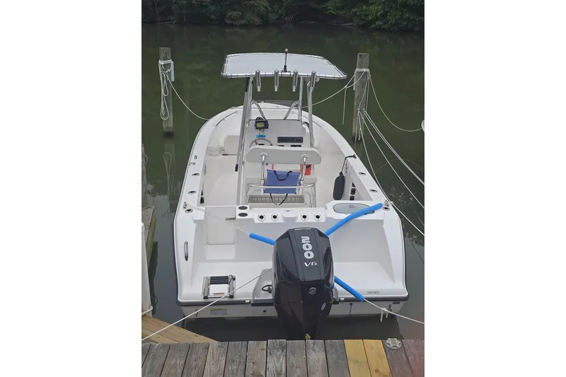 Slide: The Image of 2024 Aquasport 2200 Center Console boat docked with Yamaha 200 V6 engine. - 7
