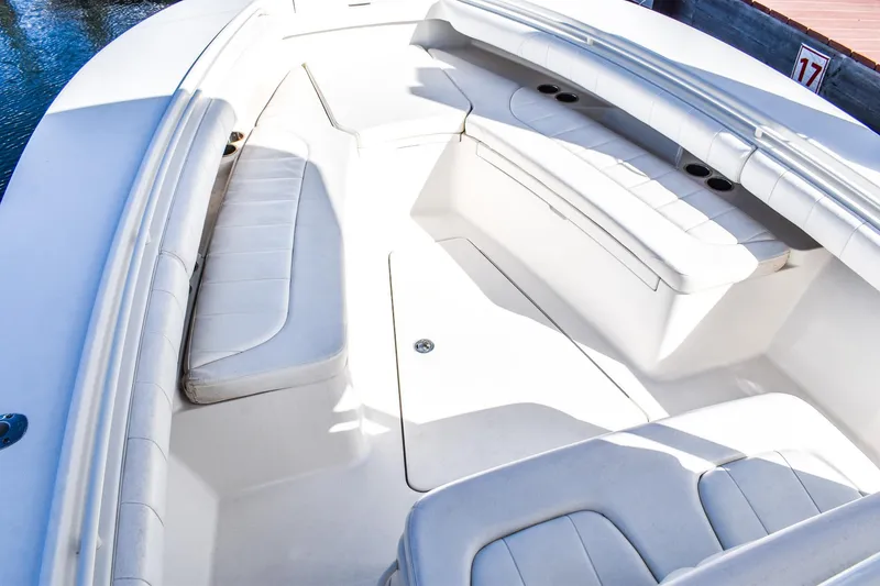 Slide: The Image of 2014 Regulator 28 boat interior with white cushioned seating and cup holders. - 10