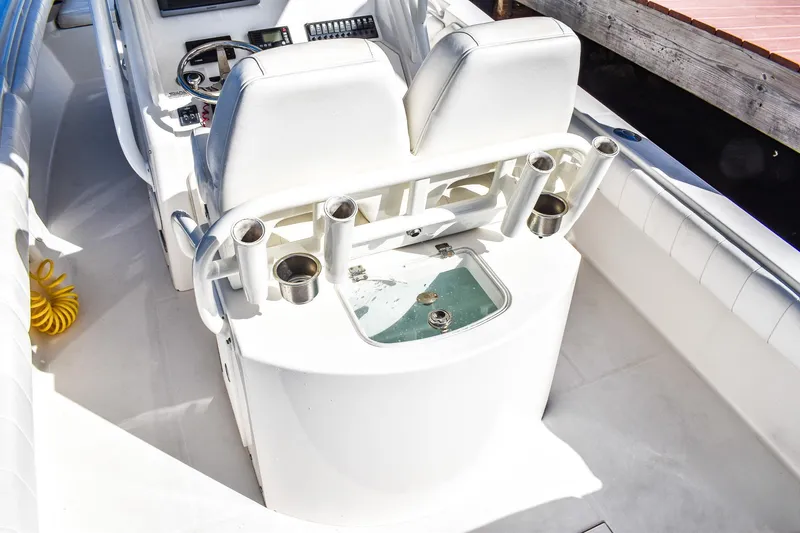 Slide: The Image of 2014 Regulator 28 boat interior with helm, seating, and rod holders. - 5
