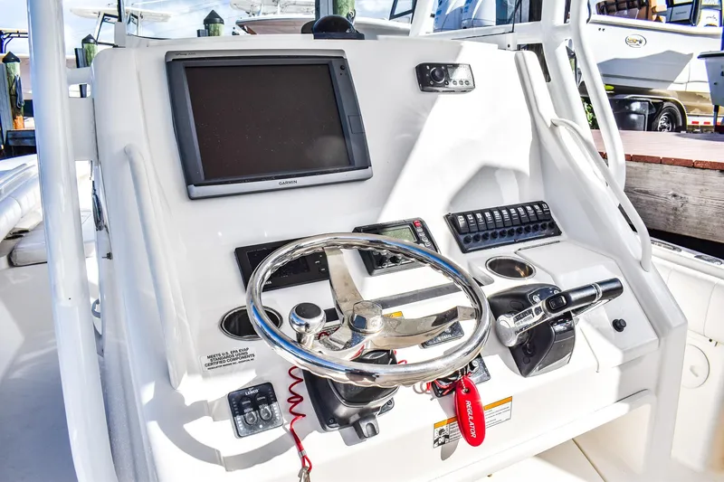 Slide: The Image of 2014 Regulator 28 boat helm with Garmin display and steering wheel. - 6