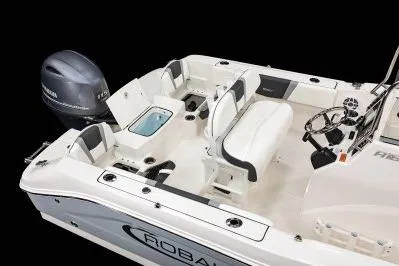 Slide: The Image of 2026 Robalo R180 Center Console boat interior with seating and Yamaha outboard motor. - 8