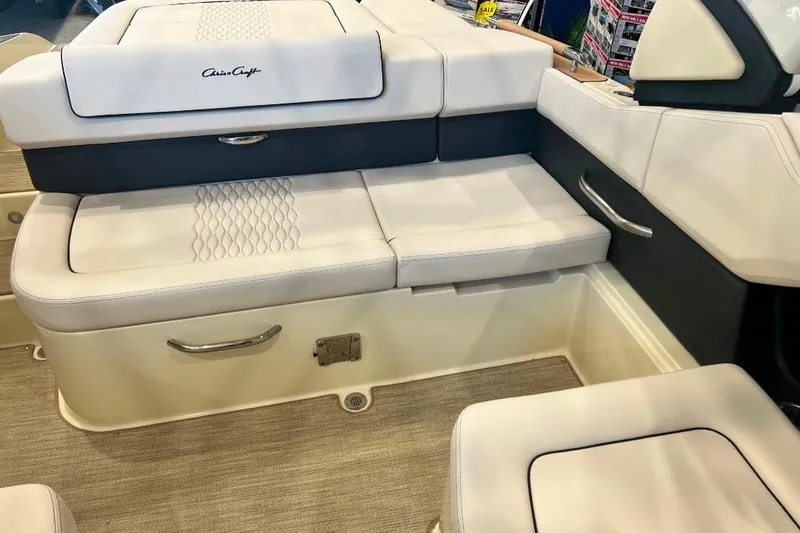 Slide: The Image of 2025 Chris-Craft Sportster 25 interior seating with elegant white upholstery and stylish design. - 10