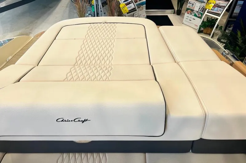 Slide: The Image of 2025 Chris-Craft Sportster 25 boat interior with luxurious beige upholstery. - 12