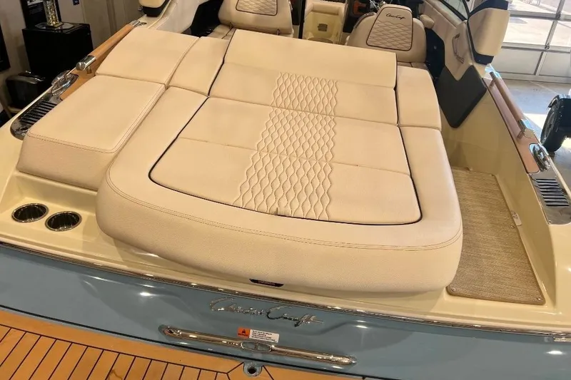 Slide: The Image of 2025 Chris-Craft Sportster 25 boat with luxurious beige seating and elegant design. - 5