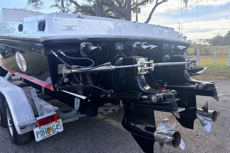 Slide: The Image of 1983 Cigarette 24' Classic boat on trailer, rear view with dual propellers. - 15