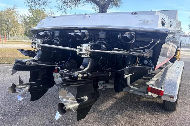 Slide: The Image of 1983 Cigarette 24' Classic boat on trailer, showcasing dual propellers and sleek design. - 16