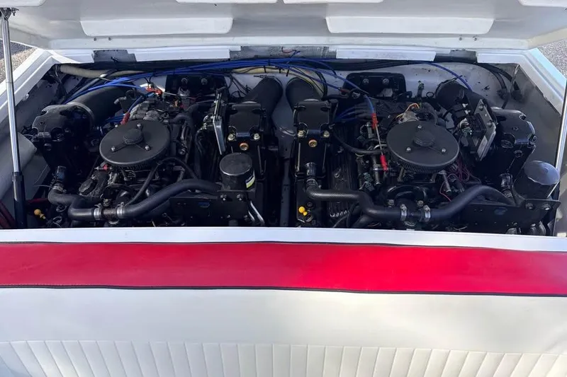 Slide: The Image of 1983 Cigarette 24' Classic boat engine compartment with dual engines visible. - 13