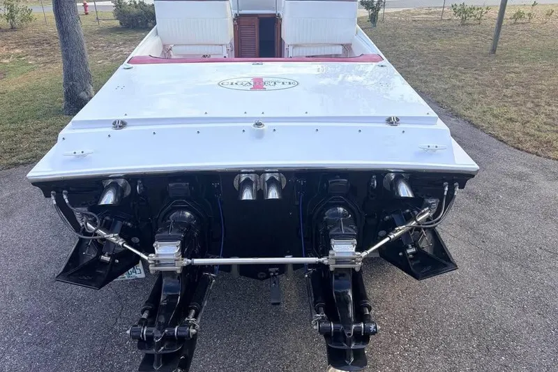 Slide: The Image of 1983 Cigarette 24' Classic boat rear view, showcasing dual engines and sleek design. - 14