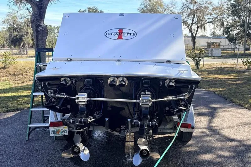 Slide: The Image of 1983 Cigarette 24' Classic boat rear view with dual propellers and logo. - 3