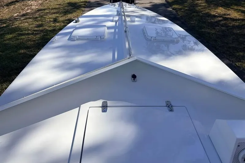 Slide: The Image of 1983 Cigarette 24' Classic boat deck, white surface, outdoor setting. - 7