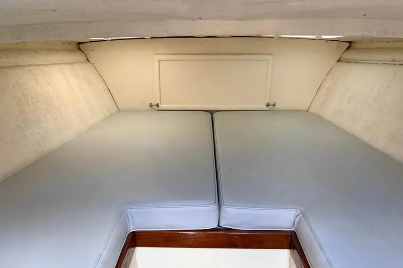 Slide: The Image of Interior cabin of a 1983 Cigarette 24' Classic boat with cushioned seating. - 8