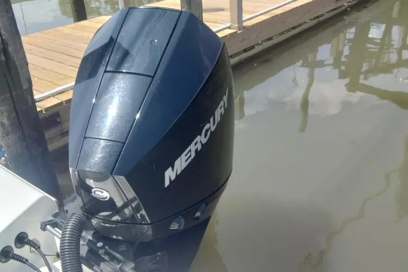 Slide: The Image of 2024 Aquasport 2200 Center Console with Mercury outboard engine at dock. - 12