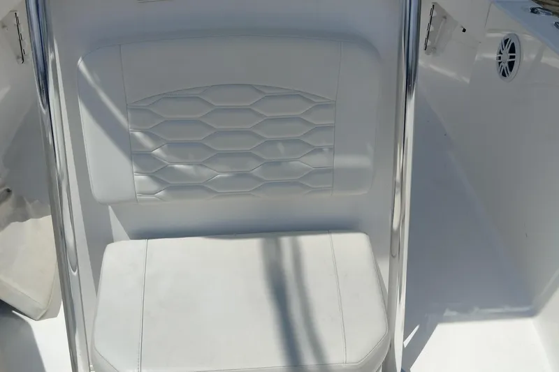 Slide: The Image of 2024 Aquasport 2200 Center Console boat seat with white upholstery and sleek design. - 5