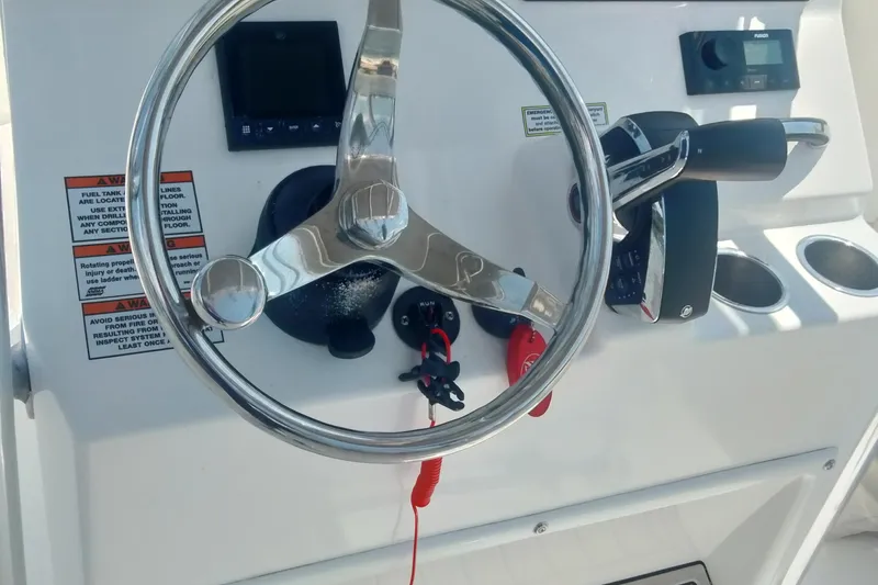 Slide: The Image of 2024 Aquasport 2200 Center Console steering wheel and controls. - 7