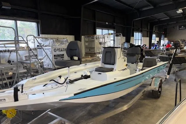 Slide: The Image of 2026 Xpress H20B Bay boat in showroom, featuring sleek design and modern seating. - 1