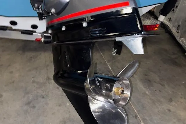 Slide: The Image of 2026 Xpress H20B Bay boat motor with shiny propeller in a garage setting. - 10