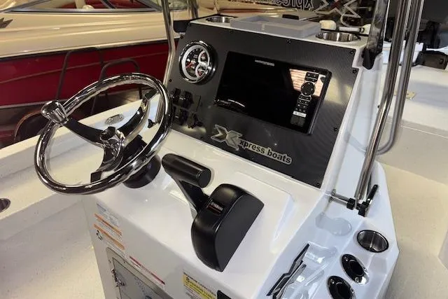 Slide: The Image of 2026 Xpress H20B Bay boat console with steering wheel and control panel. - 11