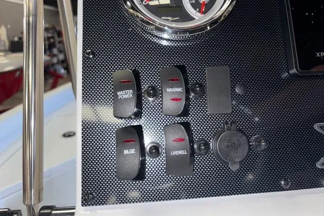 Slide: The Image of Control panel of 2026 Xpress H20B Bay boat with switches for power, navigation, bilge, and livewell. - 12