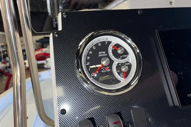 Slide: The Image of Dashboard of 2026 Xpress H20B Bay boat with RPM and fuel gauges. - 13